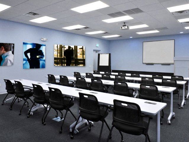 Security training classroom with rows of tables and chairs